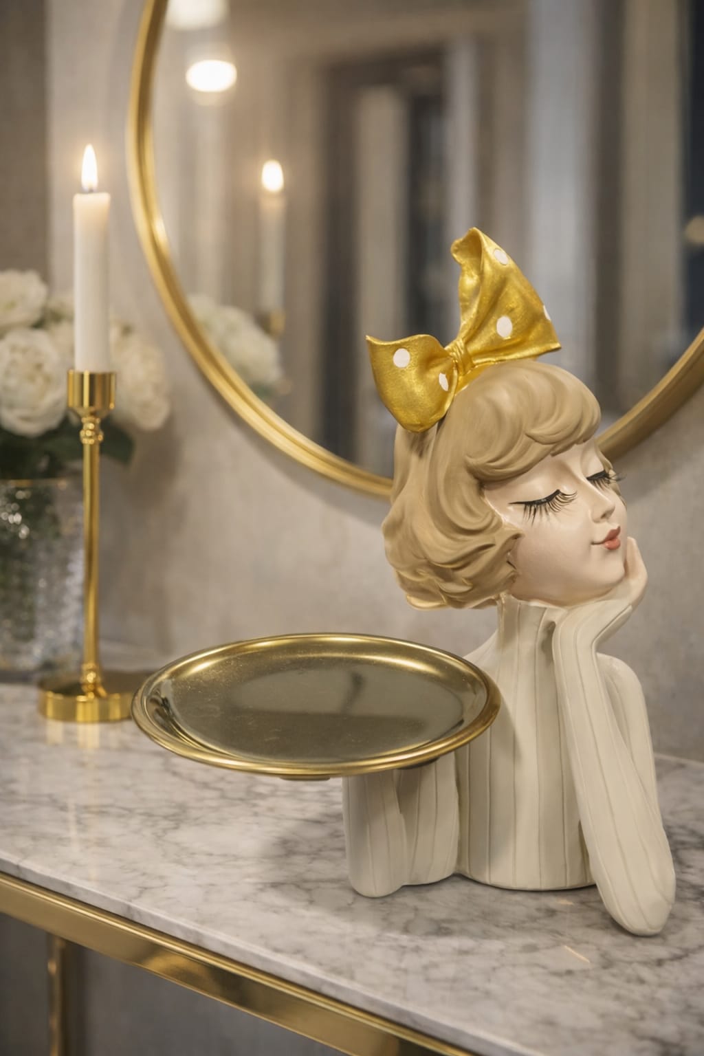 A beige girl figurine holding a gold plate