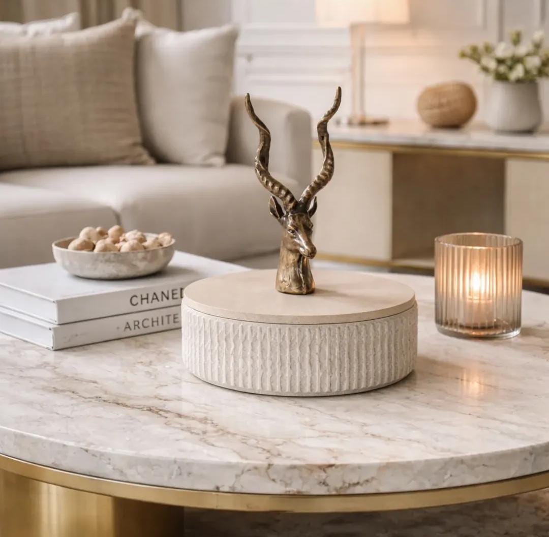 Decorative deer featuring mounted on a textured lidded storage box or pedestal