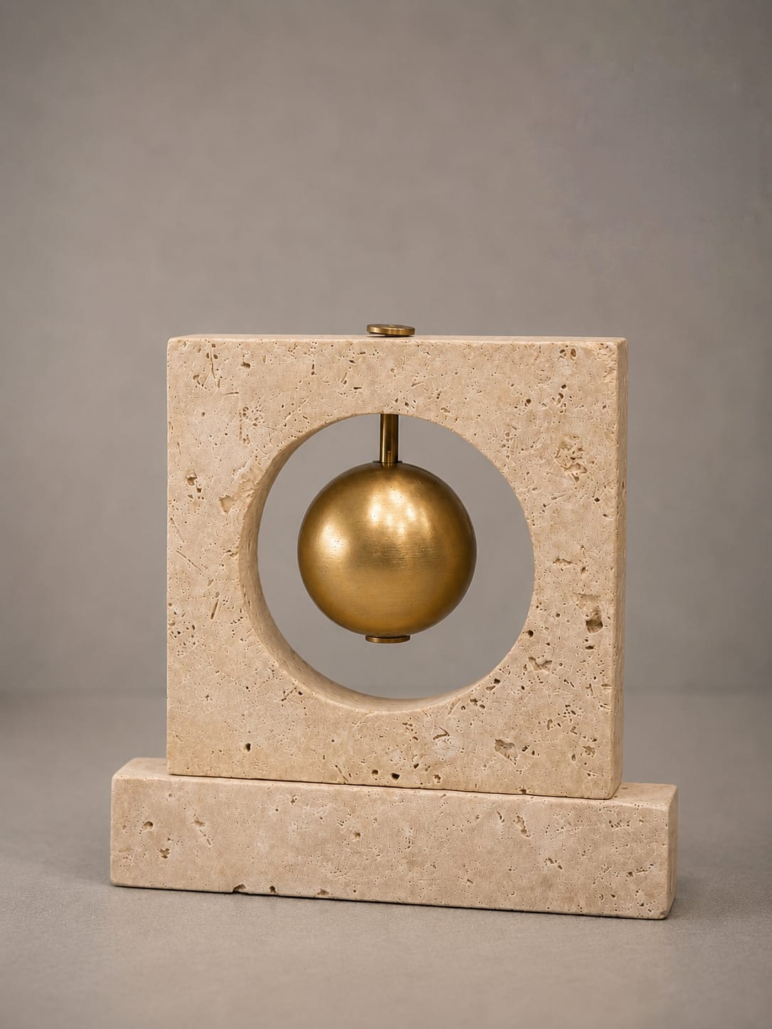 Travertine and brass decorative object with ball in half
