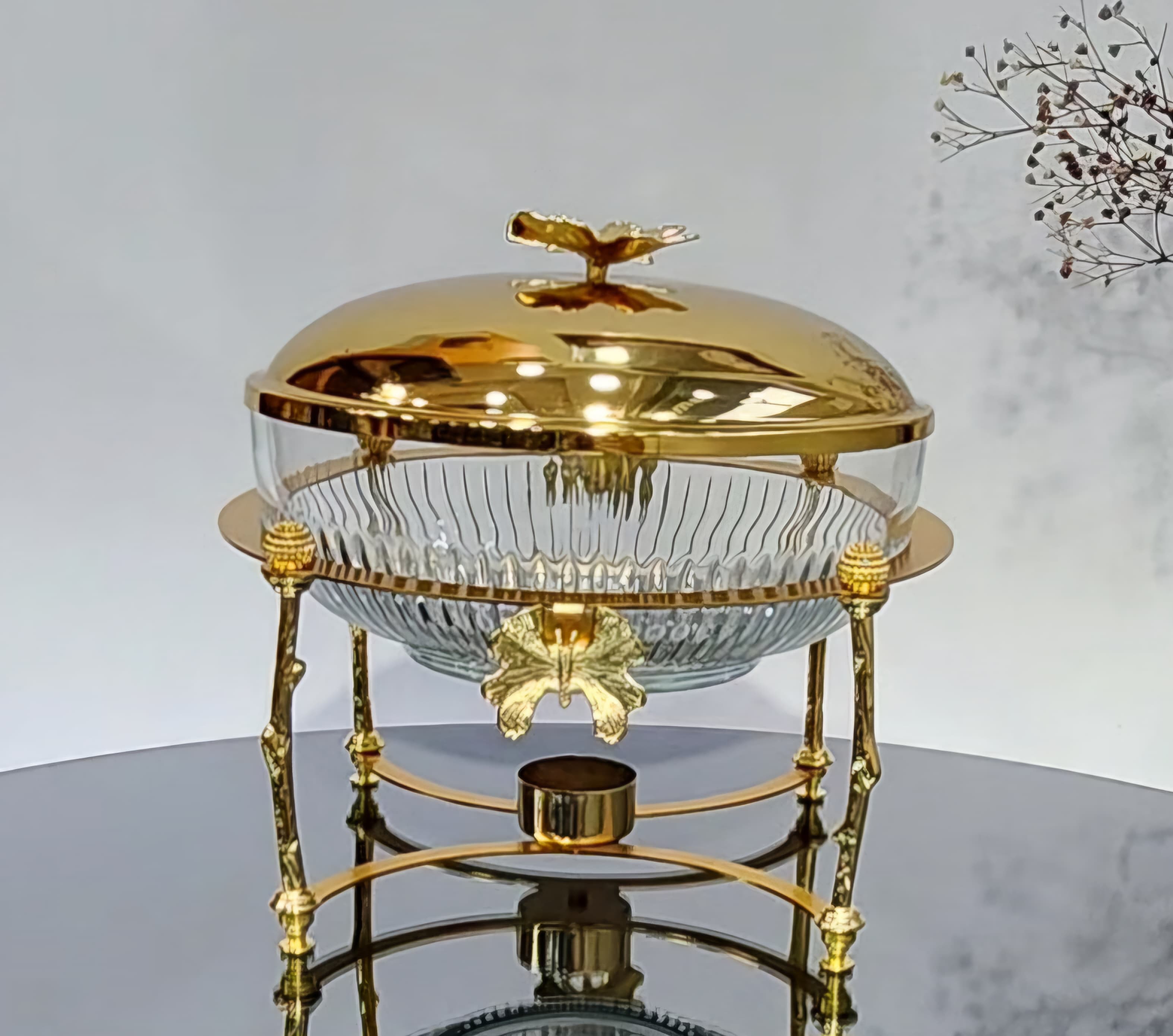 Transparent food bowl with lid with golden base and gold lid