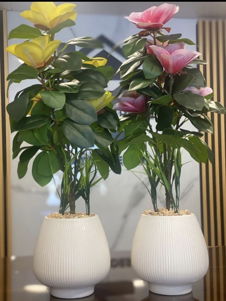decorative artificial flower arrangements in white ceramic pots