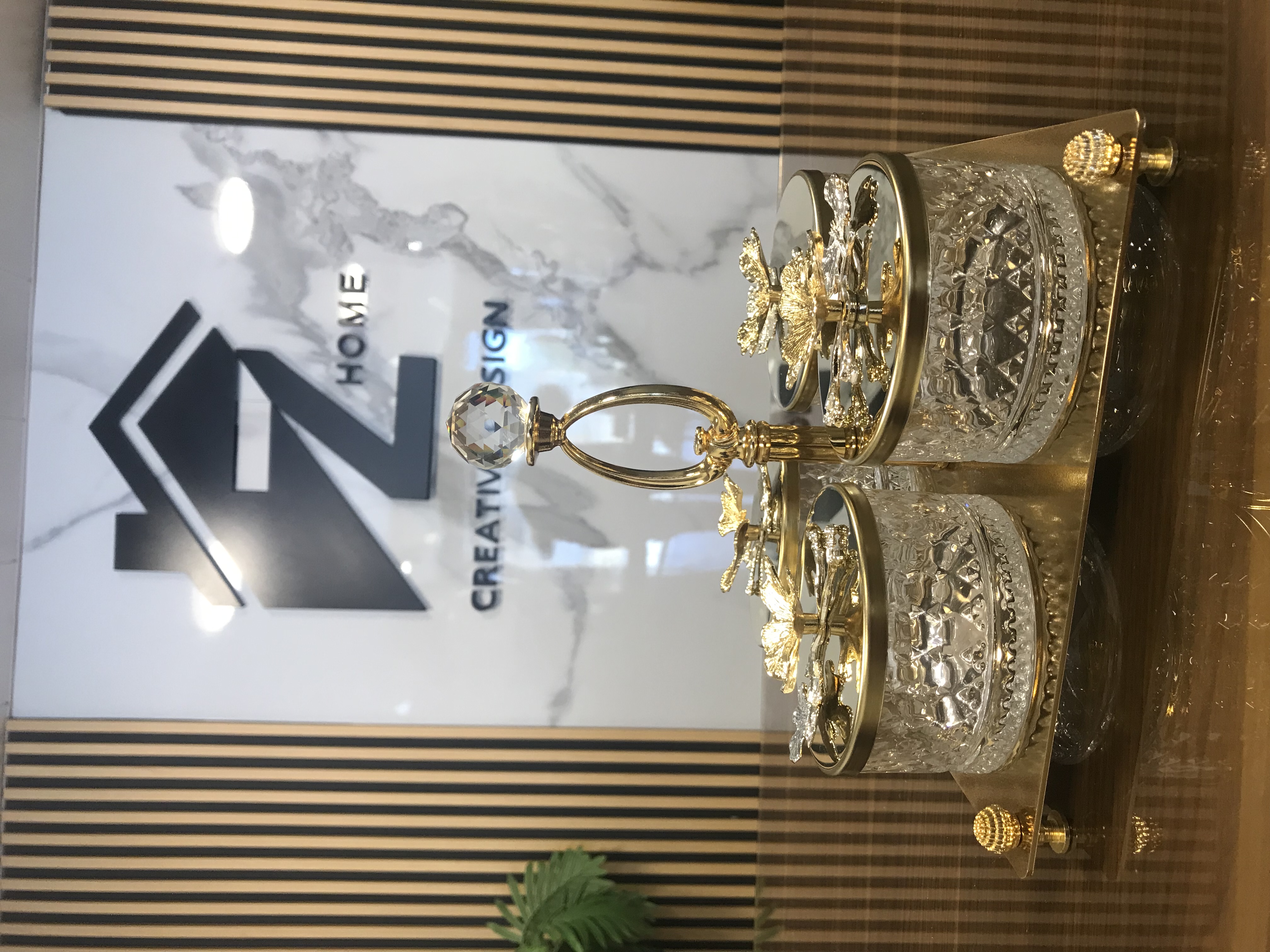 Luxury 4 crystal candy jars with golden lids and floral accents on a decorative gold tray